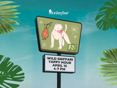 A roadside sign shows a white bulldog cartoon, tropical leaves frame the blue sky, and text advertises &ldquo;Wild Sniffari Yappy Hour&rdquo; on April 15, 4&ndash;7 PM.