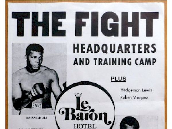This image is a vintage fight poster promoting a training camp and headquarters at Le Baron Hotel, featuring boxers in training, including Hedgemon Lewis.