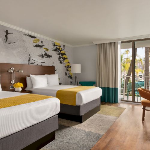 A modern hotel room with two beds, a desk, large window, and artwork on the wall, leading to a balcony with a view.