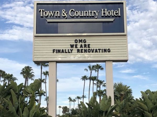 A &ldquo;Town & Country Hotel&rdquo; sign reads: &ldquo;OMG, we are finally renovating,&rdquo; with palm trees and a blue sky behind it.