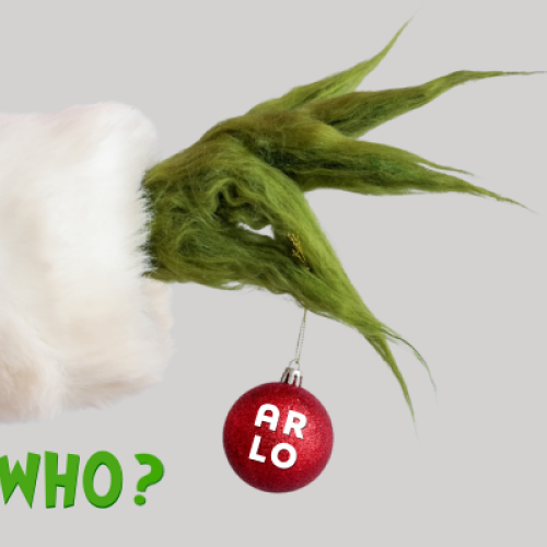 A green, furry hand dressed in red and white holds a red ornament labeled "ARLO." Green text below reads "GUESS WHO?"