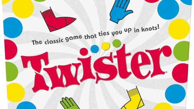 The image shows the box cover of the Twister game, featuring colorful dots and the slogan "The classic game that ties you up in knots!".
