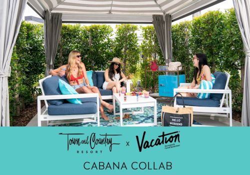 Four people relax in a stylish outdoor cabana with seating and greenery, promoting "Town and Country Resort x Vacation Cabana Collab."