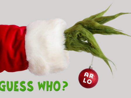 A green hand in a red Santa sleeve holds a bauble with "ARLO" text, next to "GUESS WHO?" in green text.